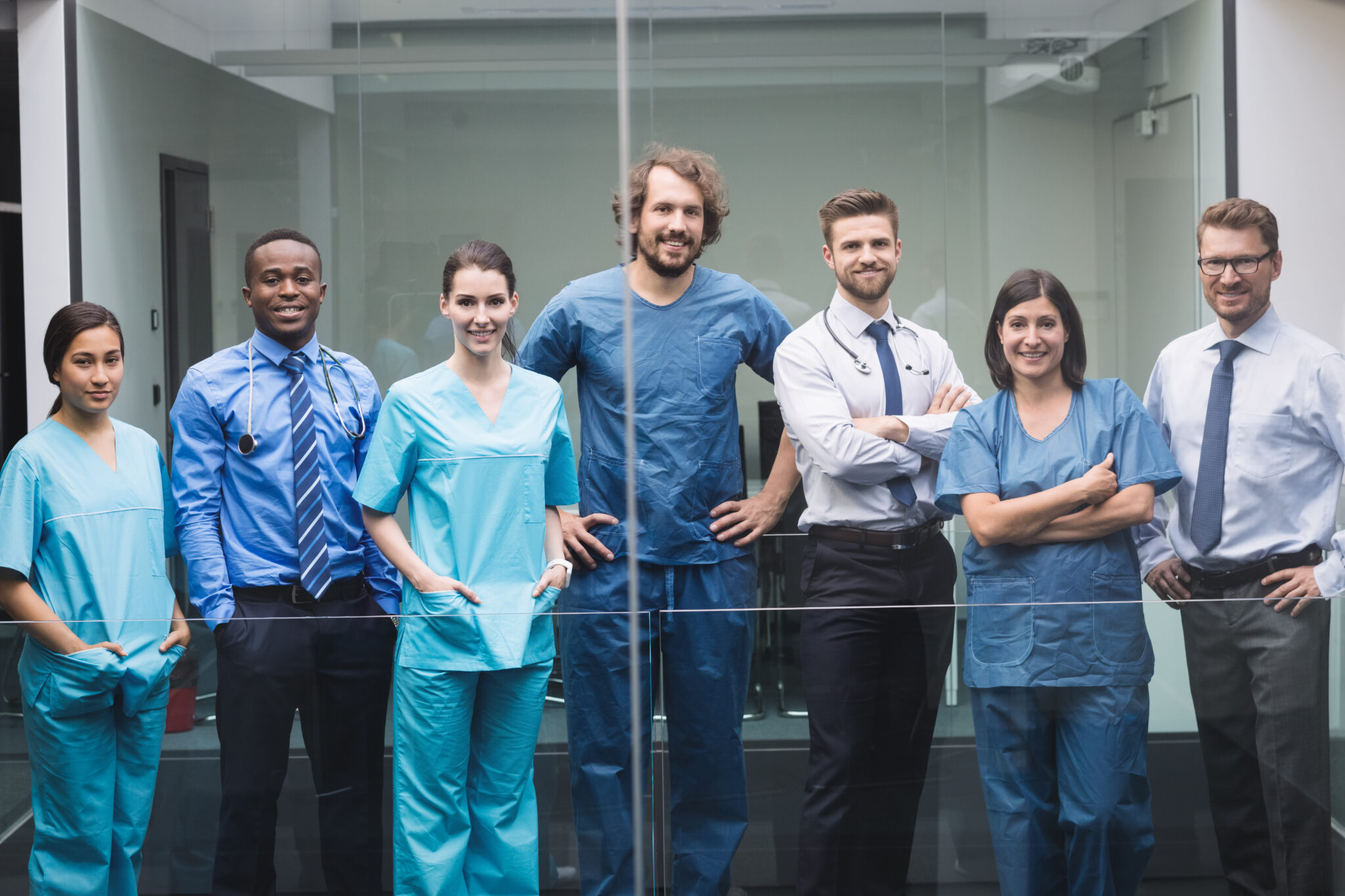 Portrait of smiling doctors standing together in corridor at hospital